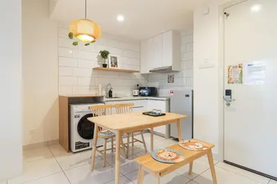 a kitchen with a table and chairs and a refrigerator at up tp 9pax with Slide, Rock Climbing, Arcade, near City & MITEC in Kuala Lumpur