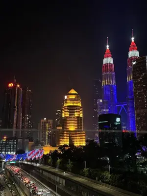 a night view of a city with tall buildings at AF Guesthouse Kampung Baru, KL in Kuala Lumpur