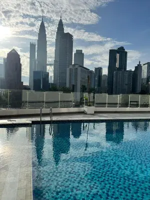 a swimming pool with a city skyline in the background at AF Guesthouse Kampung Baru, KL in Kuala Lumpur