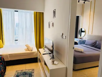 a bedroom with two beds and a tv and a window at Axon Residensi Bukit Bintang in Kuala Lumpur