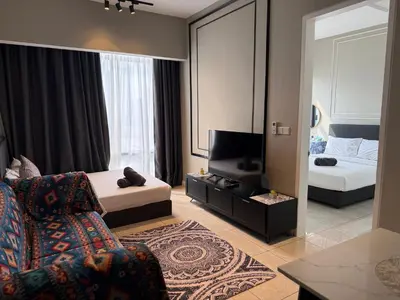 a bedroom with a couch and a bed and a television at Axon Residensi Bukit Bintang in Kuala Lumpur