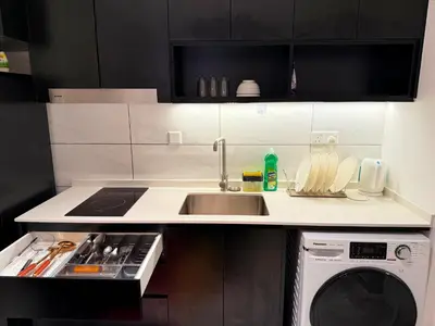 a kitchen with a sink and a washing machine at Axon Residensi Bukit Bintang in Kuala Lumpur