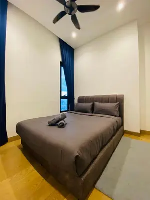 a bedroom with a large bed with a ceiling fan at Lucentia Residences Bukit Bintang KLCC By LUZBNB in Kuala Lumpur