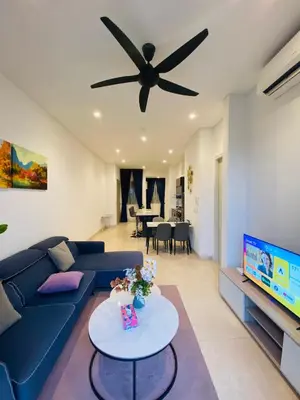 a living room with a blue couch and a ceiling fan at Lucentia Residences Bukit Bintang KLCC By LUZBNB in Kuala Lumpur