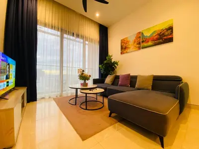 a living room with a couch and a tv at Lucentia Residences Bukit Bintang KLCC By LUZBNB in Kuala Lumpur