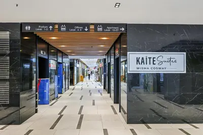 a walkway in a shopping mall with a sign on it at KAĨTE Suites at Wisma Cosway Sky Bridge to Pavilion KL in Kuala Lumpur