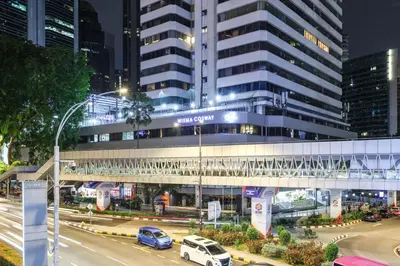 a large building with cars parked in front of it at KAĨTE Suites at Wisma Cosway Sky Bridge to Pavilion KL in Kuala Lumpur