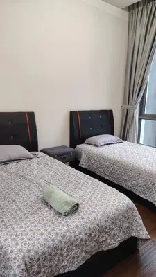a room with two beds with a pillow on it at KL29 3BR4B Jalan Ampang Near KLCC in Kuala Lumpur
