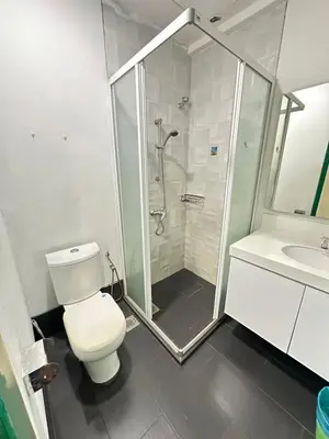 a bathroom with a shower and a toilet and a sink at Taragon Luxury Suites Bukit Bintang,Kuala Lumpur in Kuala Lumpur