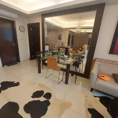 a living room with a glass table and a couch at Damas Plaza-Hartamas in Kuala Lumpur