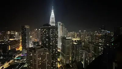 a view of a large city at night at KLCC View Penthouse in Kuala Lumpur