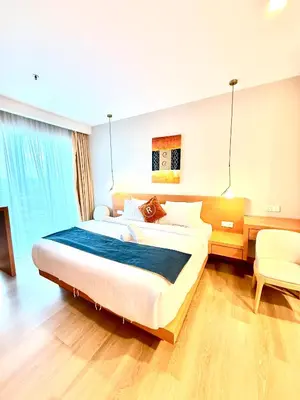 a bedroom with a large bed and a desk at Crystal Suites at Ramad KLCC in Kuala Lumpur