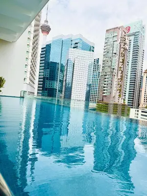 a swimming pool in a city with tall buildings at Crystal Suites at Ramad KLCC in Kuala Lumpur