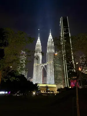 a group of tall buildings in a city at night at Crystal Suites at Ramad KLCC in Kuala Lumpur