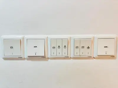 a row of light switches on a wall at Chambers Suites Kuala Lumpur by AFA in Kuala Lumpur