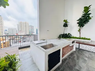 a kitchen with a sink on a balcony at Chambers Suites Kuala Lumpur by AFA in Kuala Lumpur