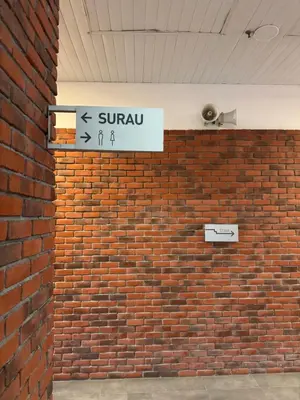 a sign on the side of a brick wall at Chambers Suites Kuala Lumpur by AFA in Kuala Lumpur