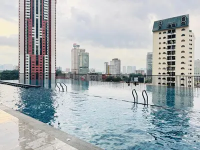 a swimming pool in a city with tall buildings at Chambers Suites Kuala Lumpur by AFA in Kuala Lumpur