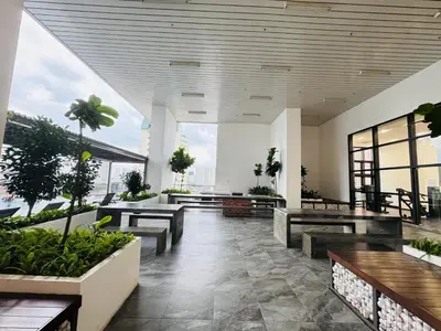 a lobby with benches and plants in a building at Chambers Suites Kuala Lumpur by AFA in Kuala Lumpur