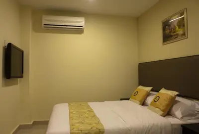 a hotel room with a bed and a air conditioner at SohoTown Hotel in Kuala Lumpur