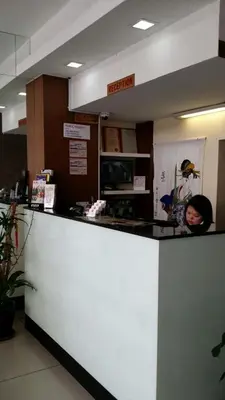 a woman standing at a counter in a restaurant at SohoTown Hotel in Kuala Lumpur