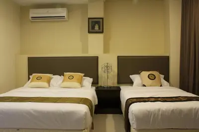two beds in a hotel room with at SohoTown Hotel in Kuala Lumpur
