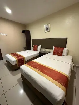 a hotel room with two beds in a room at SohoTown Hotel in Kuala Lumpur