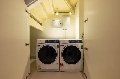 a washer and dryer in a laundry room at La Gente x Novo Ampang 3R3B Duplex Penthouse in Kuala Lumpur