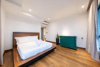a bedroom with a white bed and a green dresser at La Gente x Novo Ampang 3R3B Duplex Penthouse in Kuala Lumpur