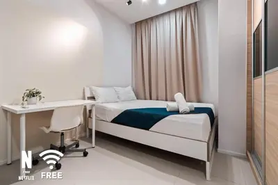 a hospital room with a bed and a desk at Arcoris Mont Kiara 3 min to 163mall 2 Bed in Kuala Lumpur