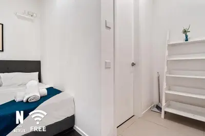 a white bedroom with a bed with towels on it at Arcoris Mont Kiara 3 min to 163mall 2 Bed in Kuala Lumpur
