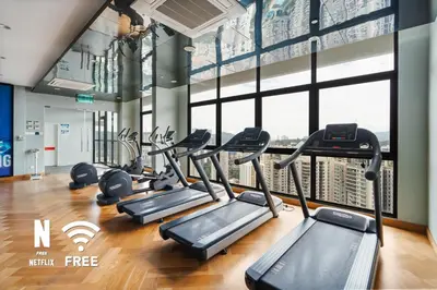 a gym with cardio equipment in a building at Mont Kiara Ooak Suite Sunway 163 with Bathtub 2 Bed in Kuala Lumpur