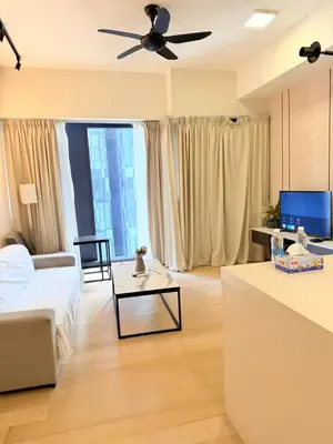 a living room with a couch and a ceiling fan at Star klcc by AR Accommodation in Kuala Lumpur