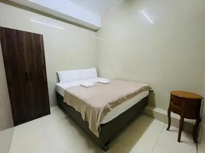 a small bedroom with a bed and a chair at Hotel City Bukit Bintang in Kuala Lumpur