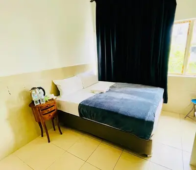 a small bedroom with a bed and a window at Hotel City Bukit Bintang in Kuala Lumpur