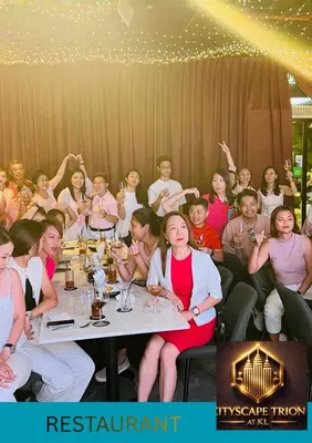 a large group of people sitting at a table at Cityscape Retreat TRION KL Premium Suites in Kuala Lumpur