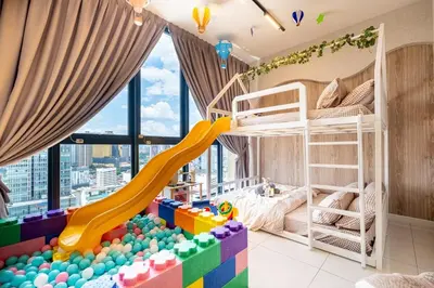 a childs room with a bunk bed and a slide at Majestic Residence By Feel Home in Kuala Lumpur