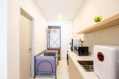 a small kitchen with a sink and a microwave at Majestic Residence By Feel Home in Kuala Lumpur