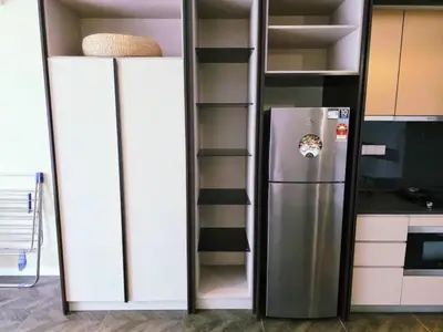 a refrigerator in a kitchen with white cabinets at Scarletz KLCC By AR Hospitality in Kuala Lumpur