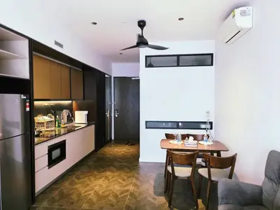 a kitchen and dining room with a table in a room at Scarletz KLCC By AR Hospitality in Kuala Lumpur