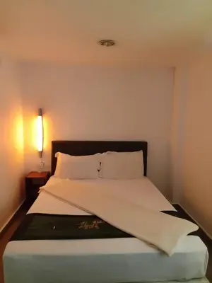 a bedroom with a bed with a black and white comforter at J Hotel Bukit Bintang in Kuala Lumpur