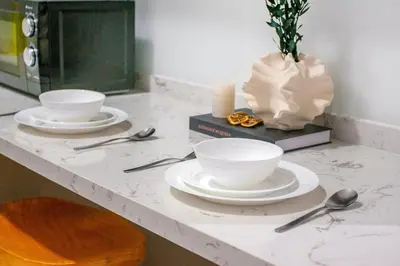 a counter with two white bowls and spoons on it at NOVO Ampang Modern Studio Infinity Pool near KLCC & Gleneagles in Kuala Lumpur