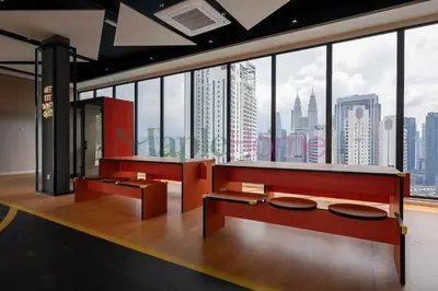 a room with two benches and a large window at Majestic Residence Premier Suites Kuala Lumpur in Kuala Lumpur