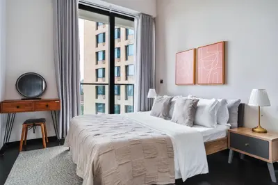 a white bedroom with a large bed and a window at Blueground Kuala Lumpur pool nr Lake Gardens KUL-1 in Kuala Lumpur
