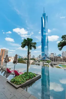 a pool with a palm tree on the roof of a building at Blueground Kuala Lumpur city view nr KL Bird Park KUL-2 in Kuala Lumpur