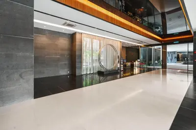 a lobby with a white floor and a large window at Blueground Kuala Lumpur city view nr KL Bird Park KUL-2 in Kuala Lumpur
