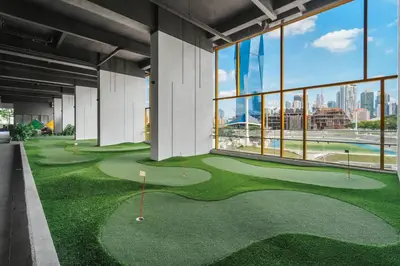 a golf course in the middle of a building with windows at Blueground Kuala Lumpur city view nr KL Bird Park KUL-2 in Kuala Lumpur