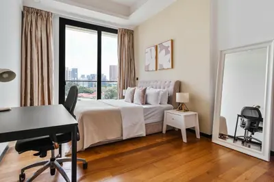 a bedroom with a bed with a desk and a window at Blueground Kuala Lumpur pool nr KL Bird Park KUL-3 in Kuala Lumpur