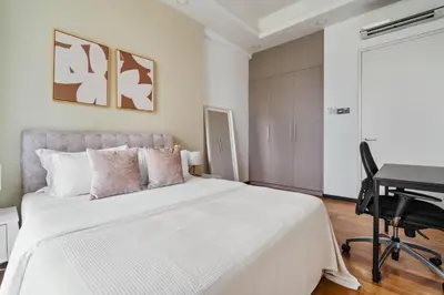 a white bedroom with a bed and a desk at Blueground Kuala Lumpur pool nr KL Bird Park KUL-3 in Kuala Lumpur