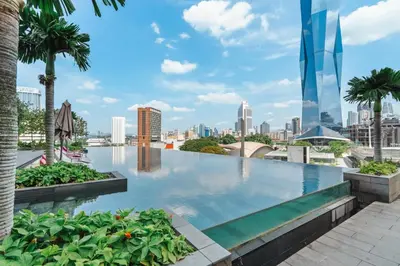 a swimming pool with a city skyline in the background at Blueground Kuala Lumpur pool nr Titiwangsa Park KUL-4 in Kuala Lumpur
